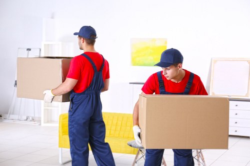 Removal van and moving team in a Hackney street