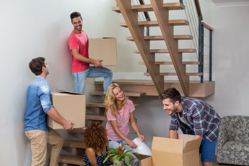 Removal van and moving team in a Hackney street