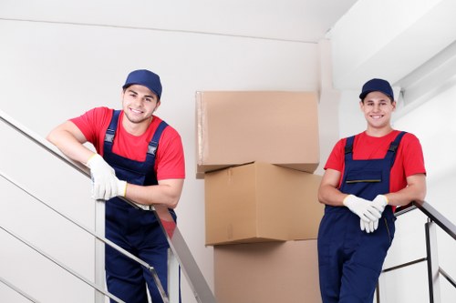 Office removals team planning a move in Hackney with desks and boxes
