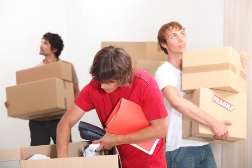 Packed office furniture and electronics ready for relocation