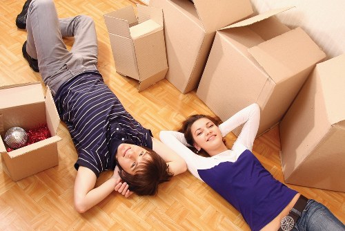 Professional movers carrying items through a Hackney apartment building